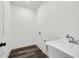 Bright laundry room with wood-look floors and utility sink at 4374 Westside Nw Dr, Acworth, GA 30101