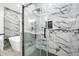 Modern bathroom shower featuring sleek glass and stylish marble-look tile at 4374 Westside Nw Dr, Acworth, GA 30101
