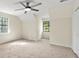 Bedroom with a ceiling fan and carpeted floors has two windows and a large closet at 9106 Kelly Ct, Jonesboro, GA 30236