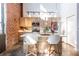 Modern kitchen with stainless steel appliances, white marble countertops, breakfast bar, and exposed brick at 195 Arizona Ne Ave # 203, Atlanta, GA 30307