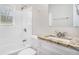 Well-lit bathroom featuring a shower-tub combo with white subway tile and granite countertop vanity at 2753 Wedgewood Ter, Decatur, GA 30032