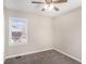 Bedroom featuring soft grey carpet, neutral walls, a ceiling fan, and a window at 2753 Wedgewood Ter, Decatur, GA 30032