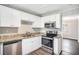 Modern kitchen featuring stainless steel appliances, granite countertops, and white cabinets at 2753 Wedgewood Ter, Decatur, GA 30032