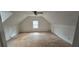 This attic space provides natural light and a ceiling fan, perfect for a flexible room design at 3640 Chandler Haulk Rd, Loganville, GA 30052