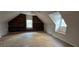 Bright attic space with built-in shelving, and natural light from the windows creating a versatile room at 3640 Chandler Haulk Rd, Loganville, GA 30052
