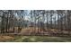 Secluded home surrounded by lush trees, providing a private and tranquil setting with water feature at 3640 Chandler Haulk Rd, Loganville, GA 30052