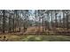 Secluded home surrounded by lush trees, providing a private and tranquil setting with water feature at 3640 Chandler Haulk Rd, Loganville, GA 30052