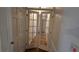 Hallway featuring elegant French doors, hardwood floors, and neutral paint, creating a bright and inviting passageway at 3640 Chandler Haulk Rd, Loganville, GA 30052