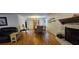 Open-concept living and dining room with hardwood floors, a fireplace, and warm, inviting decor at 3640 Chandler Haulk Rd, Loganville, GA 30052