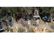An aerial view of several homes in a wooded neighborhood showing driveways and landscaping at 424 Cannonball Ct, Stockbridge, GA 30281