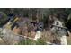 An aerial view of a home with pool, driveway, and surrounded by trees in a suburban neighborhood at 424 Cannonball Ct, Stockbridge, GA 30281