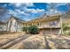 View of the home's backyard with a partially covered porch and lush shrubbery at 424 Cannonball Ct, Stockbridge, GA 30281
