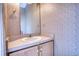 Compact half-bathroom features a stylish vanity with a mirror and natural lighting at 424 Cannonball Ct, Stockbridge, GA 30281
