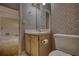 A half bath is decorated with wallpaper and features a vanity sink and toilet at 424 Cannonball Ct, Stockbridge, GA 30281