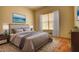Stylishly furnished bedroom showcasing a queen bed, hardwood floors, and bright natural light at 424 Cannonball Ct, Stockbridge, GA 30281