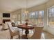 Elegant dining area with a beautiful chandelier, large windows, and comfortable seating at 424 Cannonball Ct, Stockbridge, GA 30281