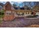 Classic home featuring brick accents, a covered front porch, and beautiful, mature trees at 424 Cannonball Ct, Stockbridge, GA 30281