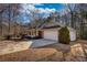 Side view of house showcasing the driveway, well-manicured lawn, and attached two-car garage at 424 Cannonball Ct, Stockbridge, GA 30281
