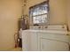 Practical laundry room equipped with washer, dryer, and water heater for convenience at 424 Cannonball Ct, Stockbridge, GA 30281