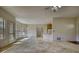 Open-concept living space featuring neutral carpet, large windows, and convenient kitchen access at 424 Cannonball Ct, Stockbridge, GA 30281