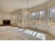 Bright living room featuring a brick fireplace, large windows, and access to the outdoors at 424 Cannonball Ct, Stockbridge, GA 30281