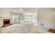 Large living room with a brick fireplace, big windows, and neutral carpet at 424 Cannonball Ct, Stockbridge, GA 30281