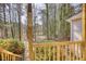 Wooden porch with rail and thermometer overlooking a wooded area at 424 Cannonball Ct, Stockbridge, GA 30281