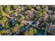 Aerial view of a home and yard surrounded by mature hardwoods in a quiet residential neighborhood at 2390 Amberbrook Sw Dr, Conyers, GA 30094