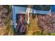 Overhead view of a house with a driveway and yard, surrounded by trees and vegetation at 2390 Amberbrook Sw Dr, Conyers, GA 30094
