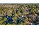 Aerial view of the home in a wooded neighborhood with mature trees on a partially cloudy day at 2390 Amberbrook Sw Dr, Conyers, GA 30094