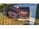 Aerial view of a house with a brown roof, surrounded by green grass and trees at 2390 Amberbrook Sw Dr, Conyers, GA 30094