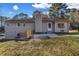 A backyard with a concrete patio and a grassy area, with trees in the background at 2390 Amberbrook Sw Dr, Conyers, GA 30094