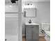 Bathroom featuring a modern sink vanity, mirror, and a walk-in shower at 2390 Amberbrook Sw Dr, Conyers, GA 30094