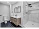 Modern bathroom featuring marble shower, sleek vanity, and black fixtures at 2390 Amberbrook Sw Dr, Conyers, GA 30094