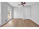 Serene bedroom featuring hardwood floors, ample natural light, and a ceiling fan, providing a comfortable retreat at 2390 Amberbrook Sw Dr, Conyers, GA 30094