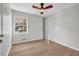 Bright bedroom with a ceiling fan and window showcasing the outdoor view at 2390 Amberbrook Sw Dr, Conyers, GA 30094