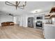 Open-concept kitchen features modern appliances and cabinets, seamlessly flowing into a comfortable living area at 2390 Amberbrook Sw Dr, Conyers, GA 30094