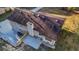 Birds eye view of the rear exterior and roof of a two-story home with deck and concrete patio in a wooded area at 2390 Amberbrook Sw Dr, Conyers, GA 30094