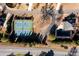 An aerial view showcasing two tennis courts, a pool, and mature trees in a well-maintained community at 5230 Harris Springs Dr, Cumming, GA 30040