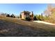 A sprawling backyard showcases mature trees and landscaping and a glimpse of a screened porch at 5230 Harris Springs Dr, Cumming, GA 30040