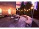 Charming backyard patio with stone pavers, string lights, and seating for outdoor entertaining at 5230 Harris Springs Dr, Cumming, GA 30040