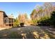 Expansive backyard with lush greenery and a screened porch perfect for entertaining at 5230 Harris Springs Dr, Cumming, GA 30040