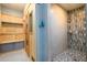 Bathroom featuring a tiled walk-in shower and a wood paneled sauna with a grey storage bench at 5230 Harris Springs Dr, Cumming, GA 30040