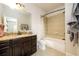 Bathroom featuring a combination tub and shower with granite countertop vanity at 5230 Harris Springs Dr, Cumming, GA 30040