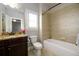 Well-lit bathroom featuring a combination tub and shower and granite countertop vanity at 5230 Harris Springs Dr, Cumming, GA 30040