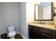 Elegant bathroom features granite countertops, dark wood cabinets, and modern fixtures at 5230 Harris Springs Dr, Cumming, GA 30040