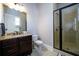 Modern bathroom boasts a glass-enclosed shower, granite countertops, and stylish fixtures at 5230 Harris Springs Dr, Cumming, GA 30040