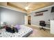 Spacious bedroom with study area, plush carpet, and ample natural light from the windows at 5230 Harris Springs Dr, Cumming, GA 30040