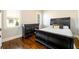 Bedroom with dark wood floors and a window with plantation shutters at 5230 Harris Springs Dr, Cumming, GA 30040