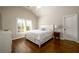 Bright bedroom with hardwood floors, large window, and white furnishings creating a clean and inviting space at 5230 Harris Springs Dr, Cumming, GA 30040